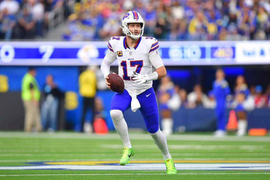 Buffalo Bills quarterback Josh Allen (17) moves out to pass against the Los Angeles Rams during the first half at SoFi Stadium.