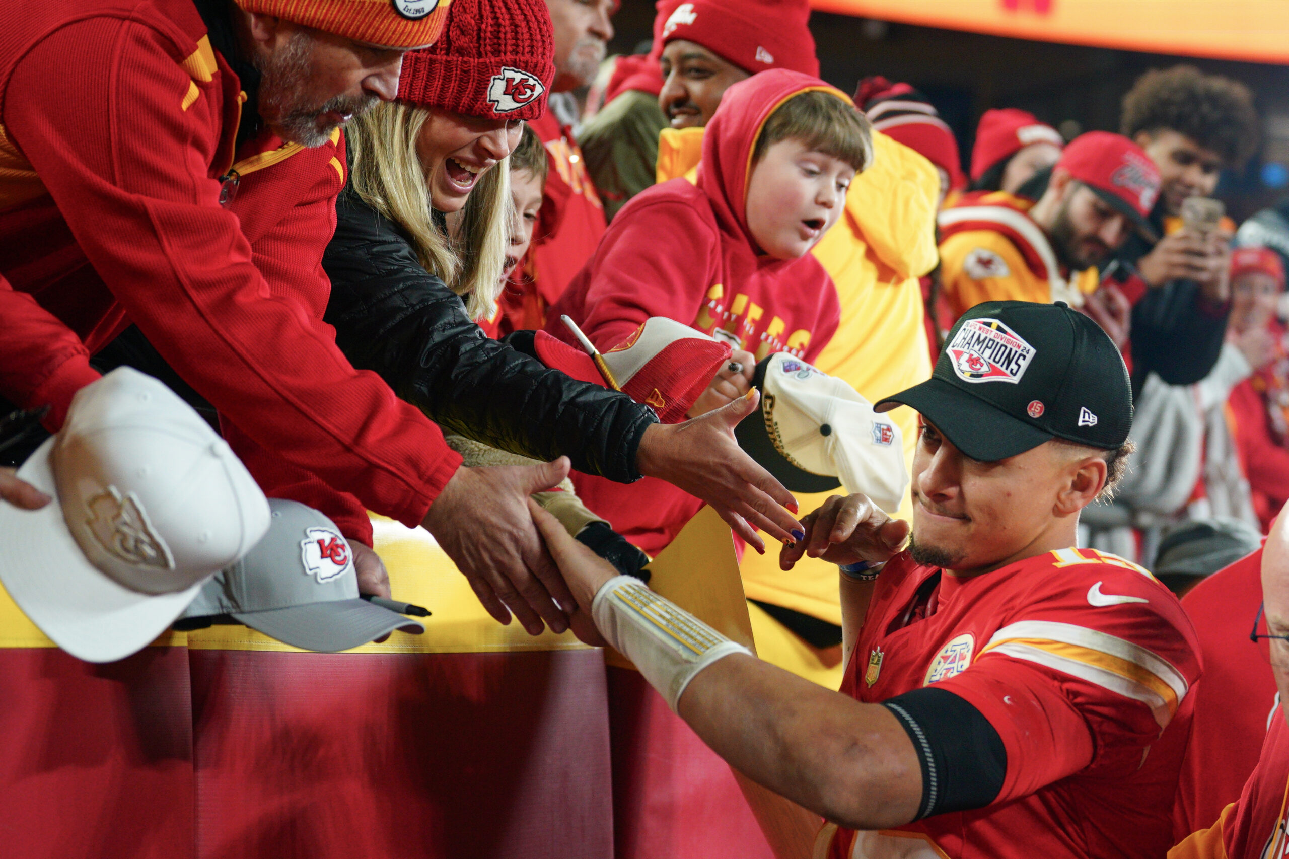 Kansas City Chiefs quarterback Patrick Mahomes (15) greets fans while leaving the field after the win over the Los Angeles Chargers at GEHA Field at Arrowhead Stadium.