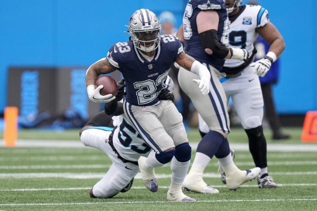 Dallas Cowboys running back Rico Dowdle (23) runs out of a tackle by Carolina Panthers linebacker Claudin Cherelus (53) during the first quarter at Bank of America Stadium. 