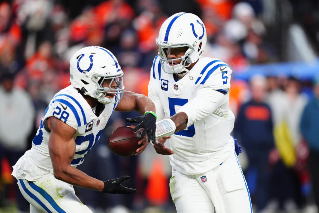 Indianapolis Colts quarterback Anthony Richardson (5) hands off to running back Jonathan Taylor (28) in the second half against the Denver Broncos at Empower Field at Mile High.