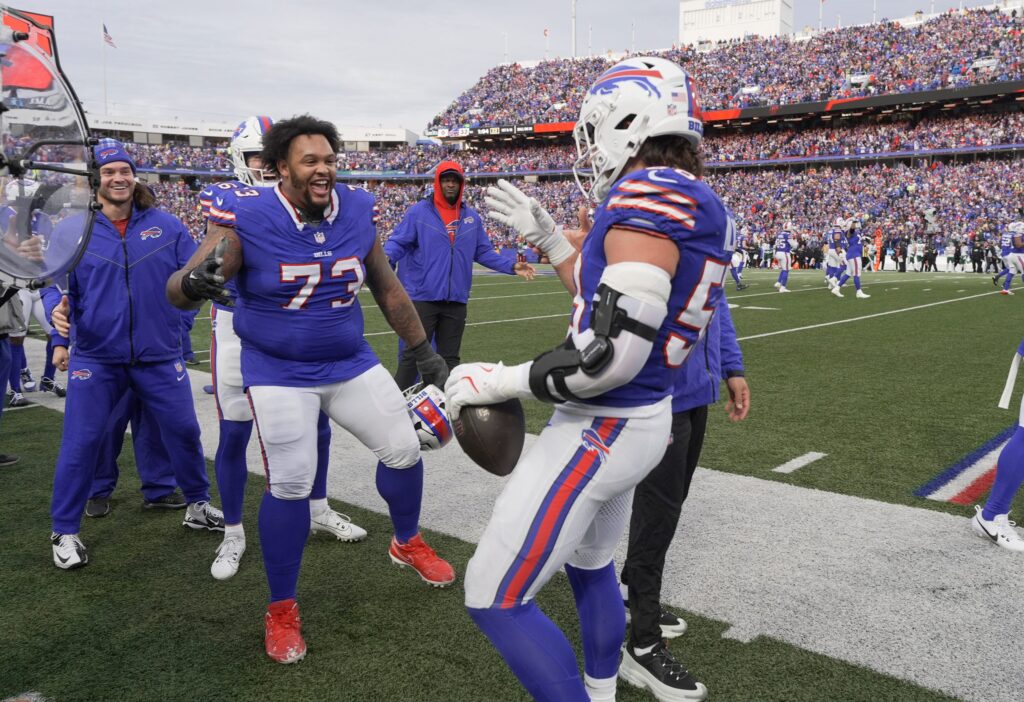 Buffalo Bills offensive tackle Dion Dawkins (73) celebrates with Buffalo Bills linebacker Matt Milano (58) fumble recovery at Highmark Stadium in Orchard Park.