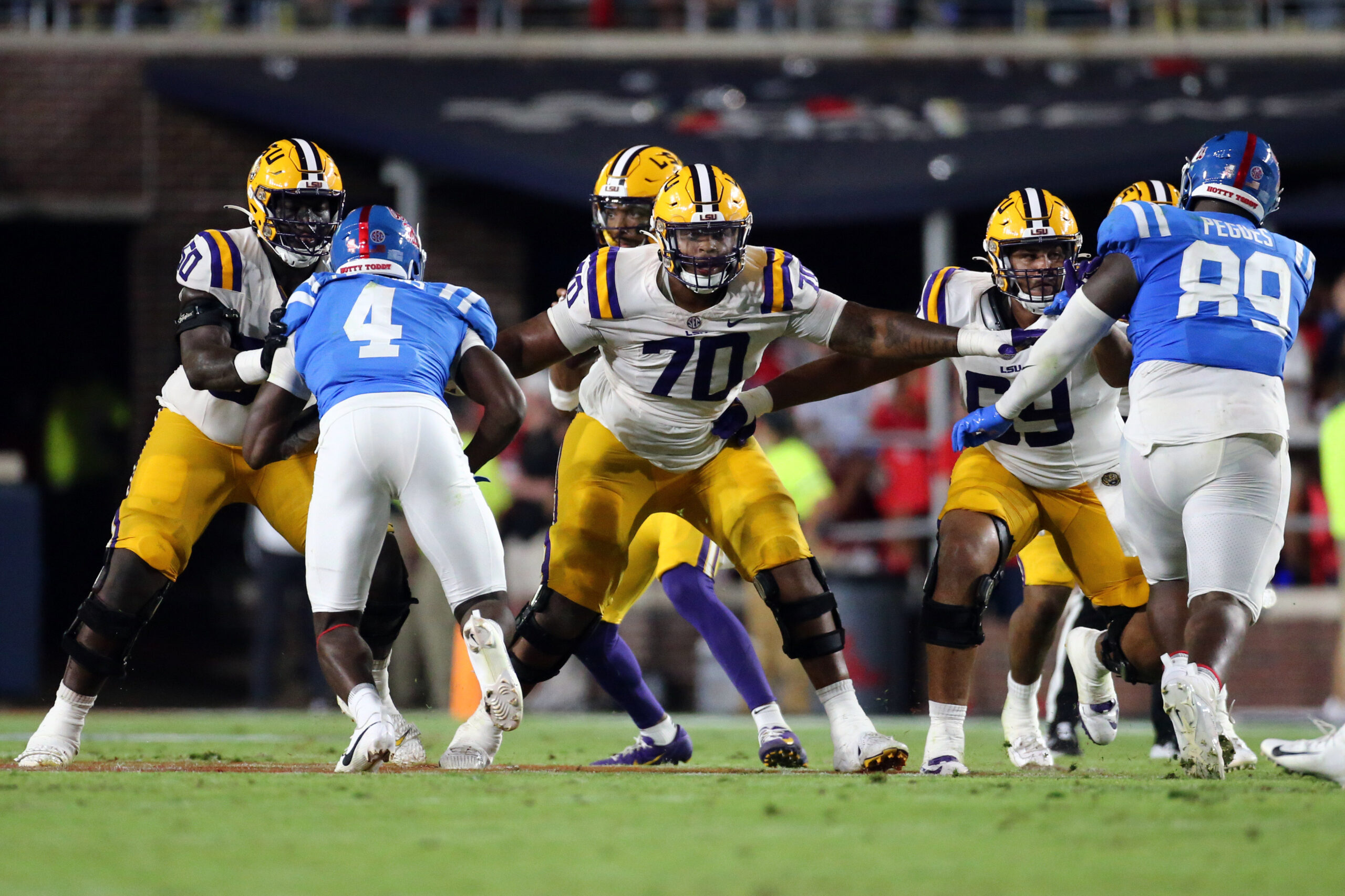 LSU Tigers offensive linemen Emery Jones Jr. (50), Miles Frazier (70) and Charles Turner III (69) block during the second half against the Mississippi Rebels.