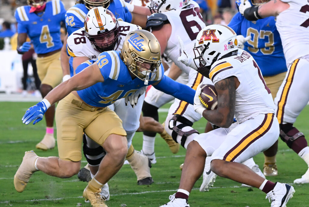 UCLA Bruins linebacker Carson Schwesinger (49) moves to tackle Minnesota Golden Gophers running back Darius Taylor (1) during the first half at Rose Bowl.