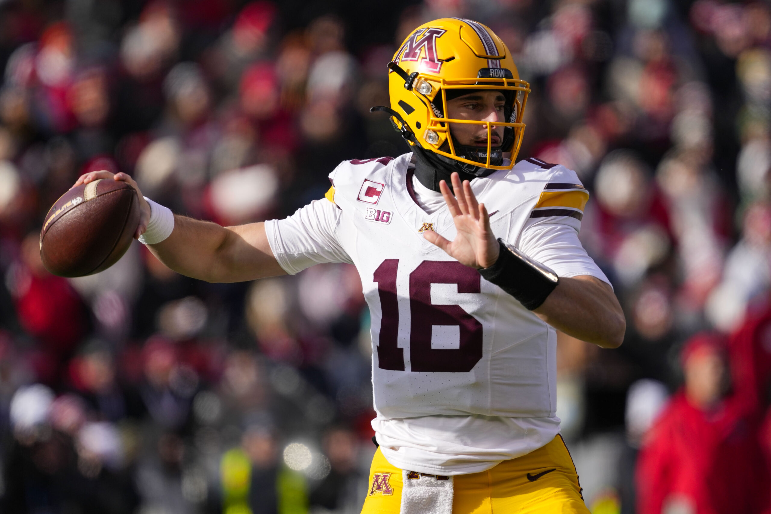 Minnesota Golden Gophers quarterback Max Brosmer (16) throws a pass during the first quarter against the Wisconsin Badgers at Camp Randall Stadium.