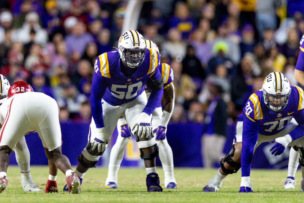 LSU Tigers offensive lineman Emery Jones Jr. (50) defends the line against Oklahoma Sooners defensive lineman R Mason Thomas (32) during the first quarter at Tiger Stadium. 
