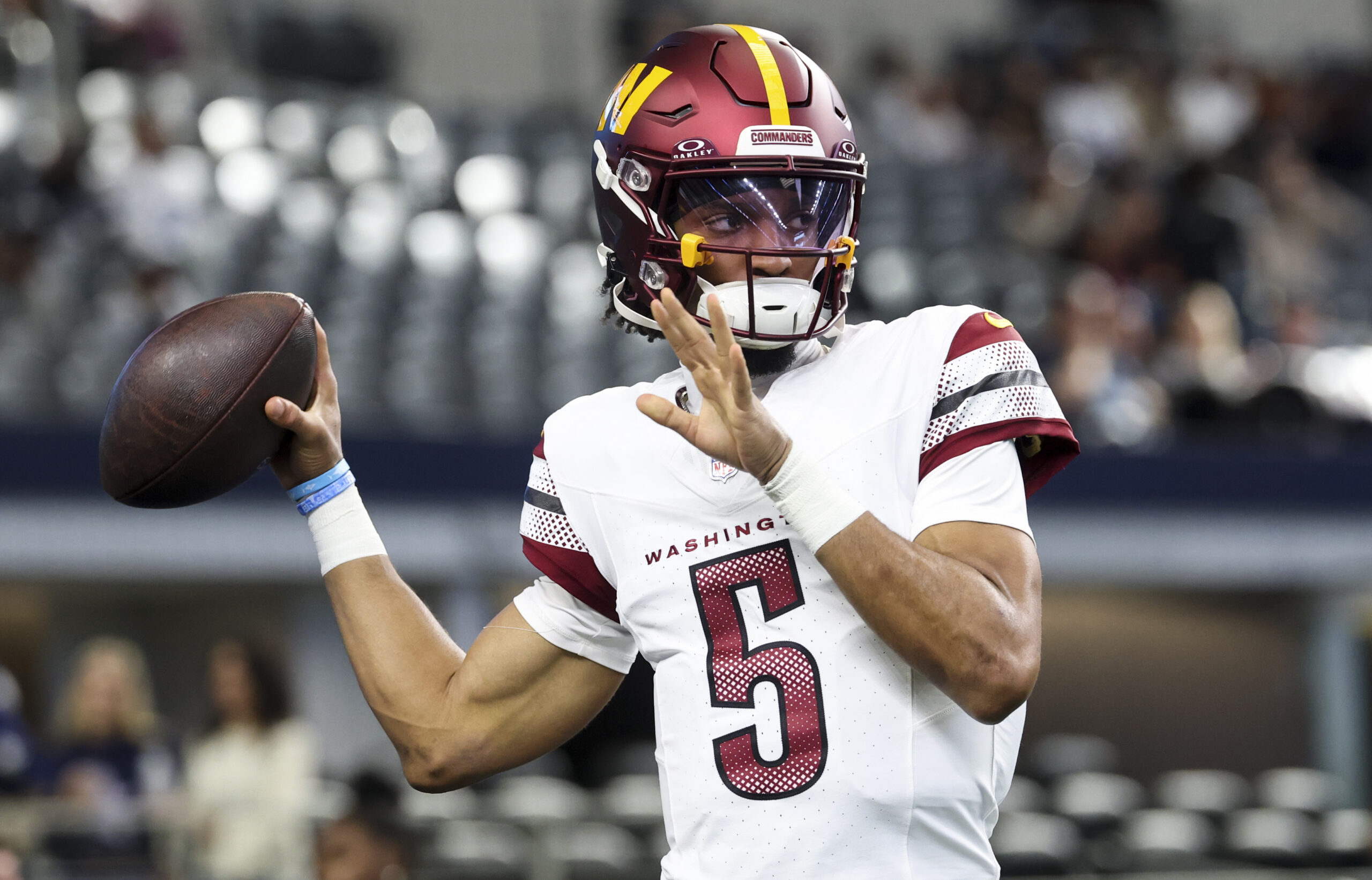 Washington Commanders quarterback Jayden Daniels (5) warms up before the game against the Dallas Cowboys at AT&T Stadium.