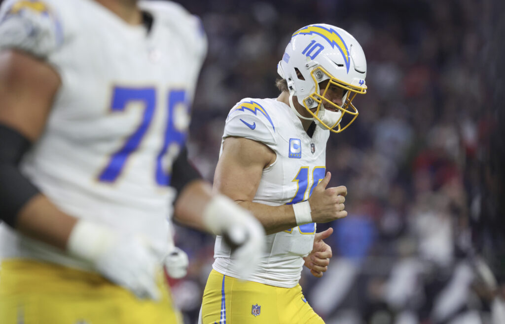 Los Angeles Chargers quarterback Justin Herbert (10) jogs off the field after a play during the game against the Houston Texans in an AFC wild card game at NRG Stadium.