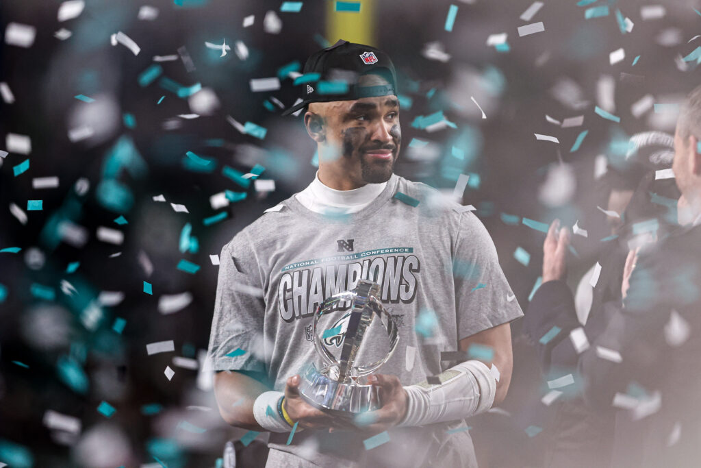Philadelphia Eagles quarterback Jalen Hurts (1) holds the NFC Championship trophy after a victory in the NFC Championship game against the Washington Commanders at Lincoln Financial Field.