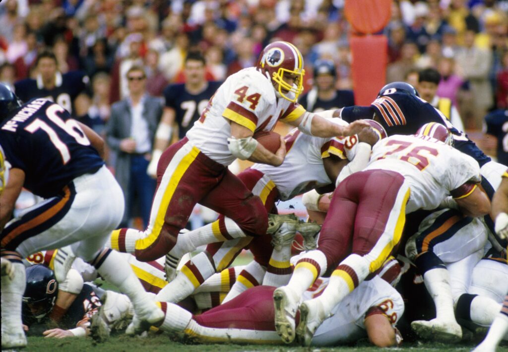 Washington Redskins running back John Riggins (44) carries the ball against the Chicago Bears during the 1984 NFC Divisional Playoff Game at RFK Stadium. The Bears won 23-19. 