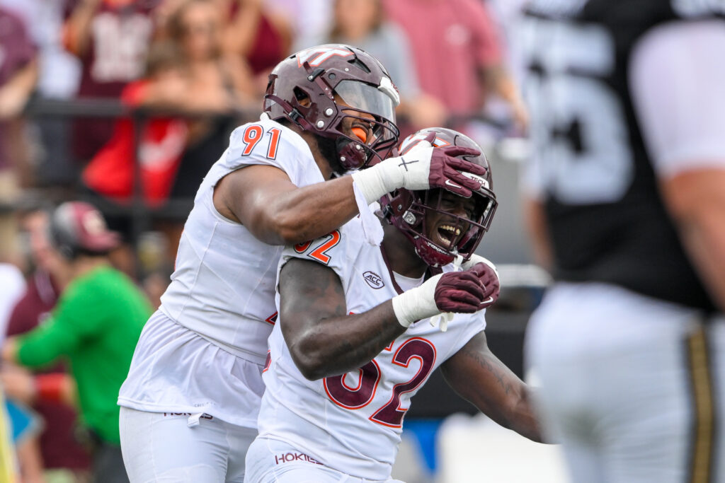 Virginia Tech Hokies defensive lineman Wilfried Pene (91) and Virginia Tech Hokies defensive lineman Antwaun Powell-Ryland (52) celebratione a sack against the Vanderbilt Commodores.