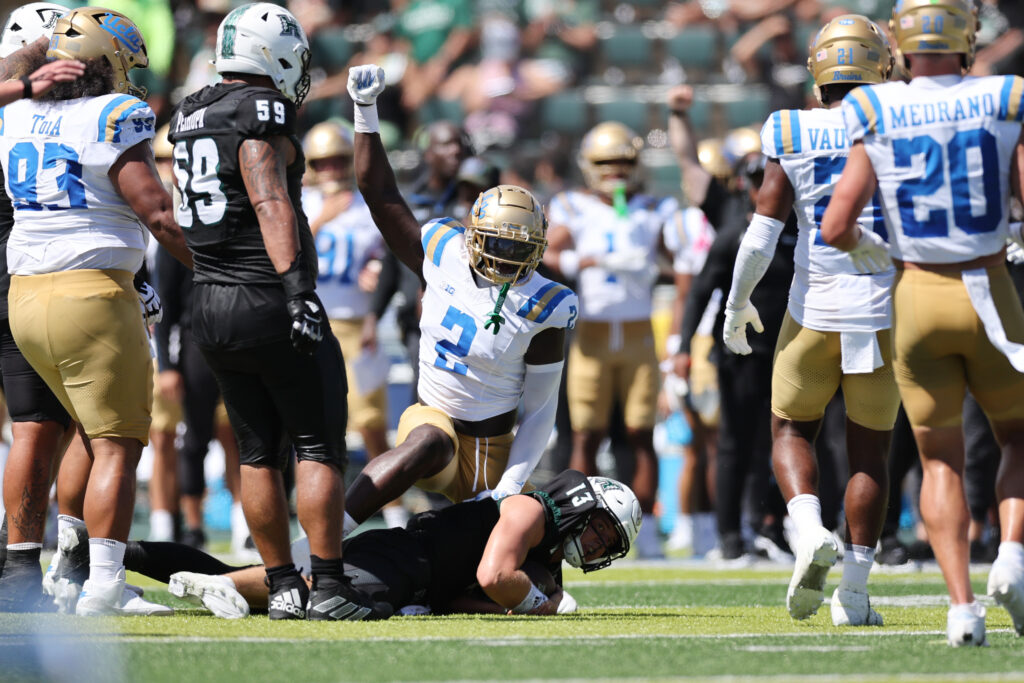 UCLA Bruins linebacker Oluwafemi Oladejo (2) reacts after tackling Hawaii Rainbow Warriors quarterback Brayden Schager (13).