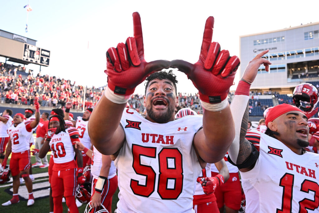 Utah Utes defensive tackle Junior Tafuna (58) celebrates with teammates after defeating the Utah State Aggies at Merlin Olsen Field at Maverik Stadium. 