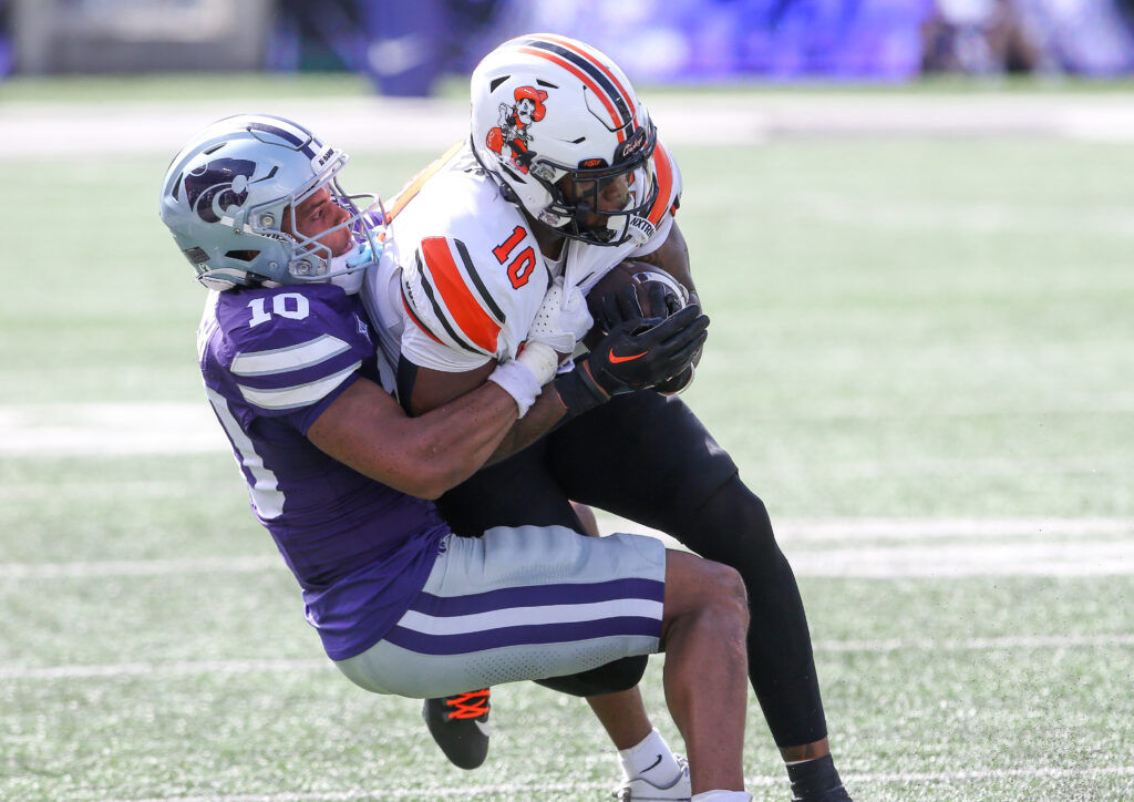 Oklahoma State Cowboys wide receiver Rashod Owens (10) is brought down by Kansas State Wildcats cornerback Jacob Parrish (10) during the second quarter at Bill Snyder Family Football Stadium. 