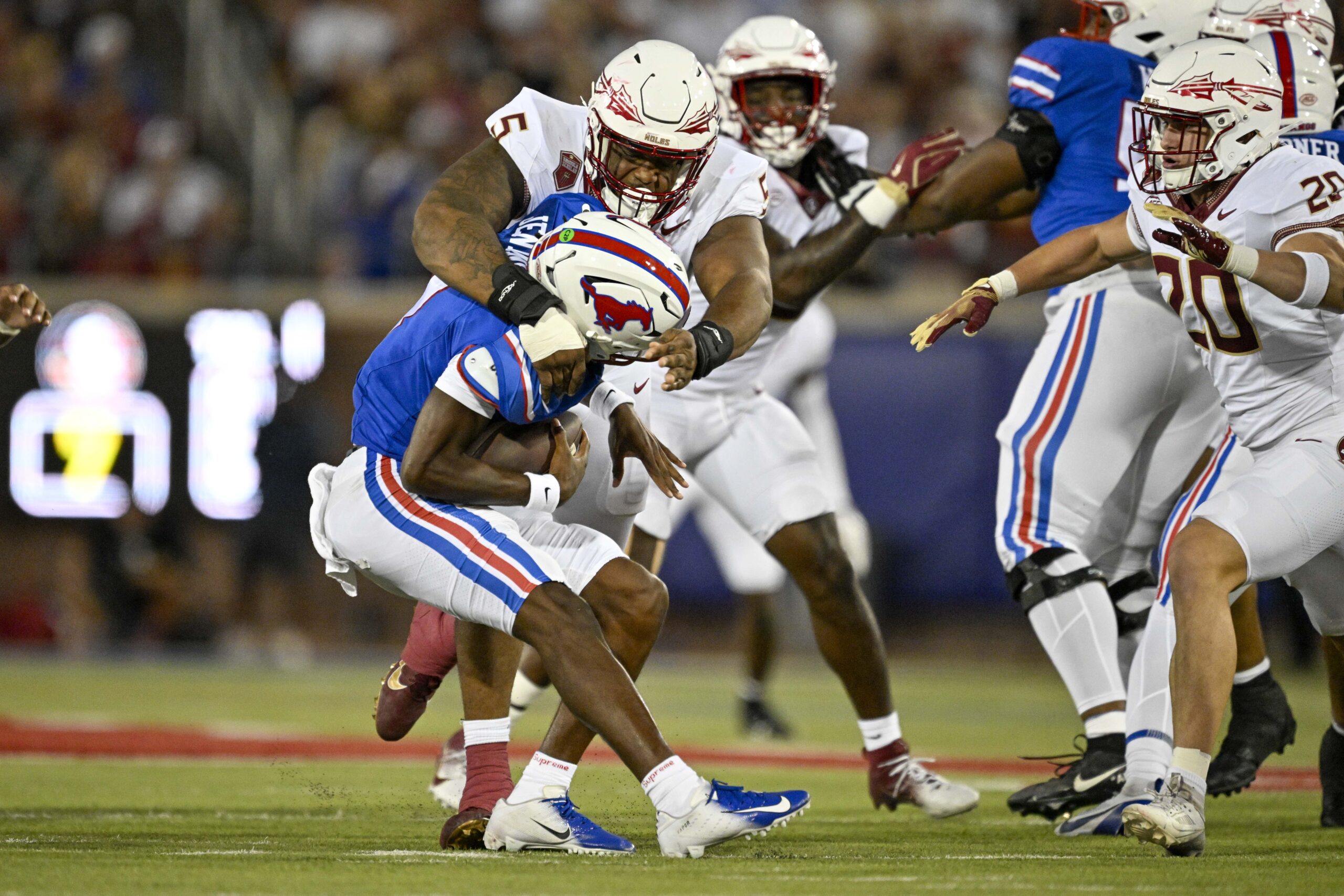 Florida State Seminoles defensive lineman Joshua Farmer (5) attempts to tackle Southern Methodist Mustangs quarterback Kevin Jennings (7) during the first quarter.
