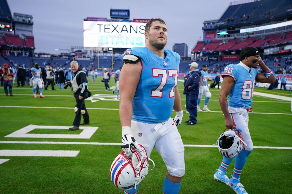 Tennessee Titans offensive tackle Peter Skoronski (77) and wide receiver Bryce Oliver (80) leave the field after the game with the Houston Texans at Nissan Stadium.