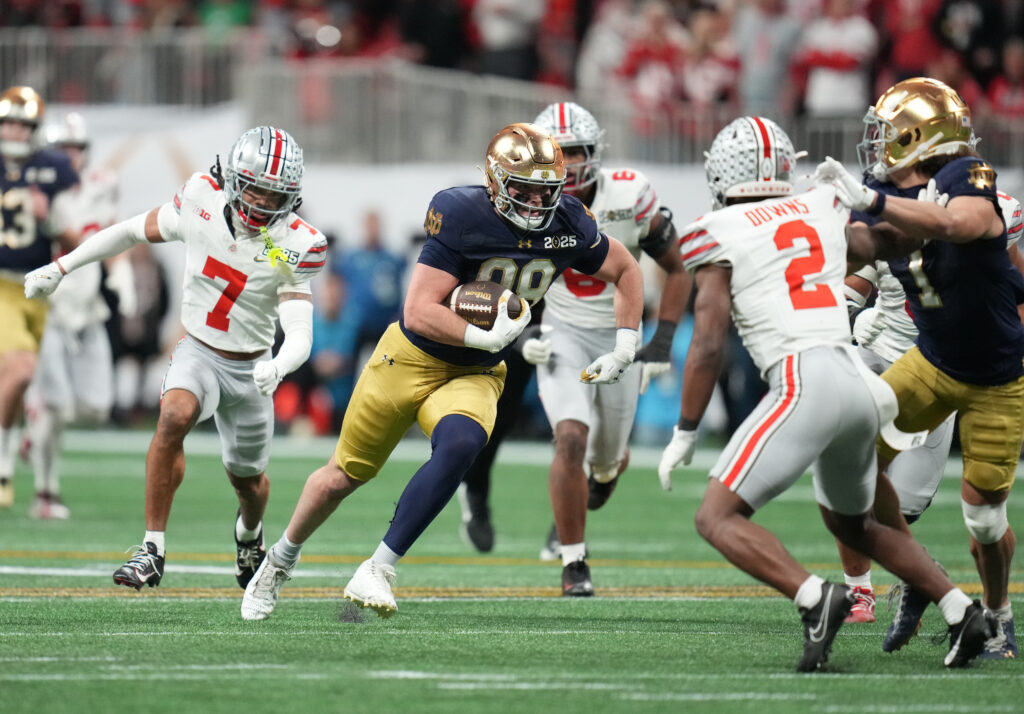 Notre Dame Fighting Irish tight end Mitchell Evans (88) runs the ball against the Ohio State Buckeyes in the second half in the CFP National Championship college football. 