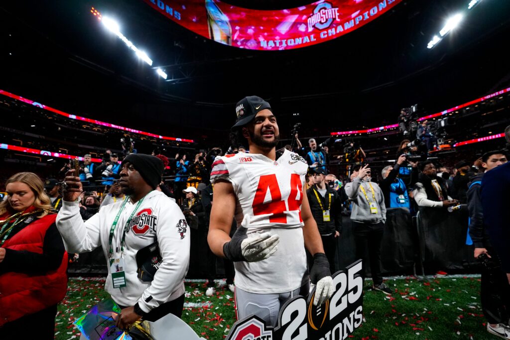 Ohio State Buckeyes defensive end JT Tuimoloau (44) celebrates after defeating Notre Dame Fighting Irish in the College Football Playoff championship game at Mercedes-Benz Stadium.