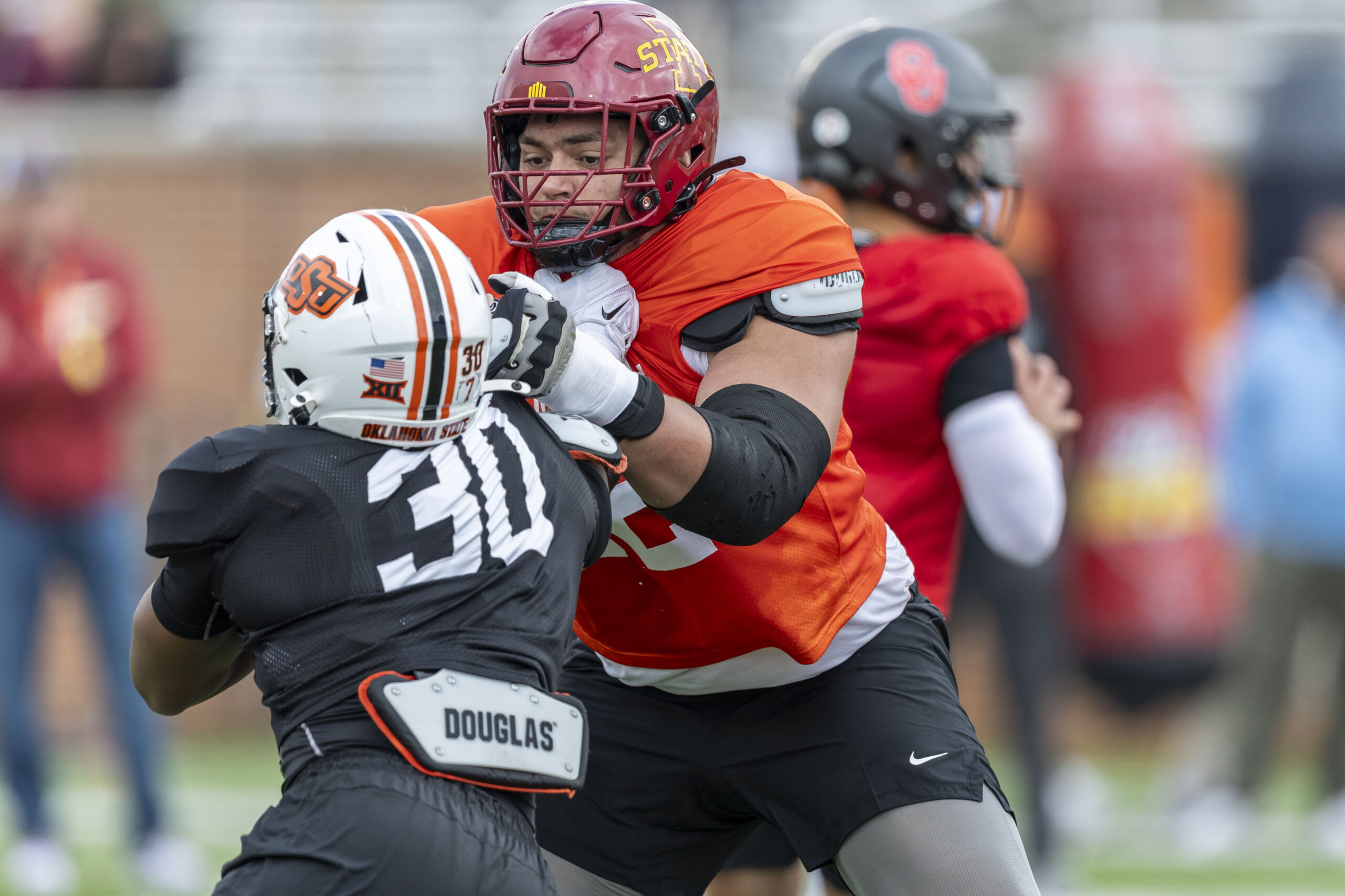 National team offensive lineman Jalen Travis of Iowa State (72) works against National team defensive lineman Collin Oliver of Oklahoma State (30) during Senior Bowl.